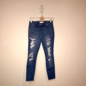 Ripped jeans with raw fringe bottom